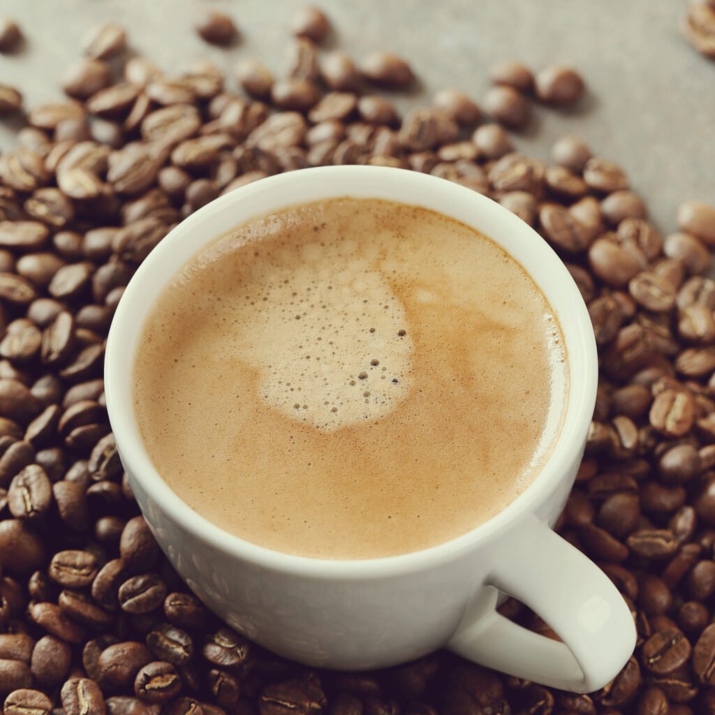 Black coffee with coffee beans on the table